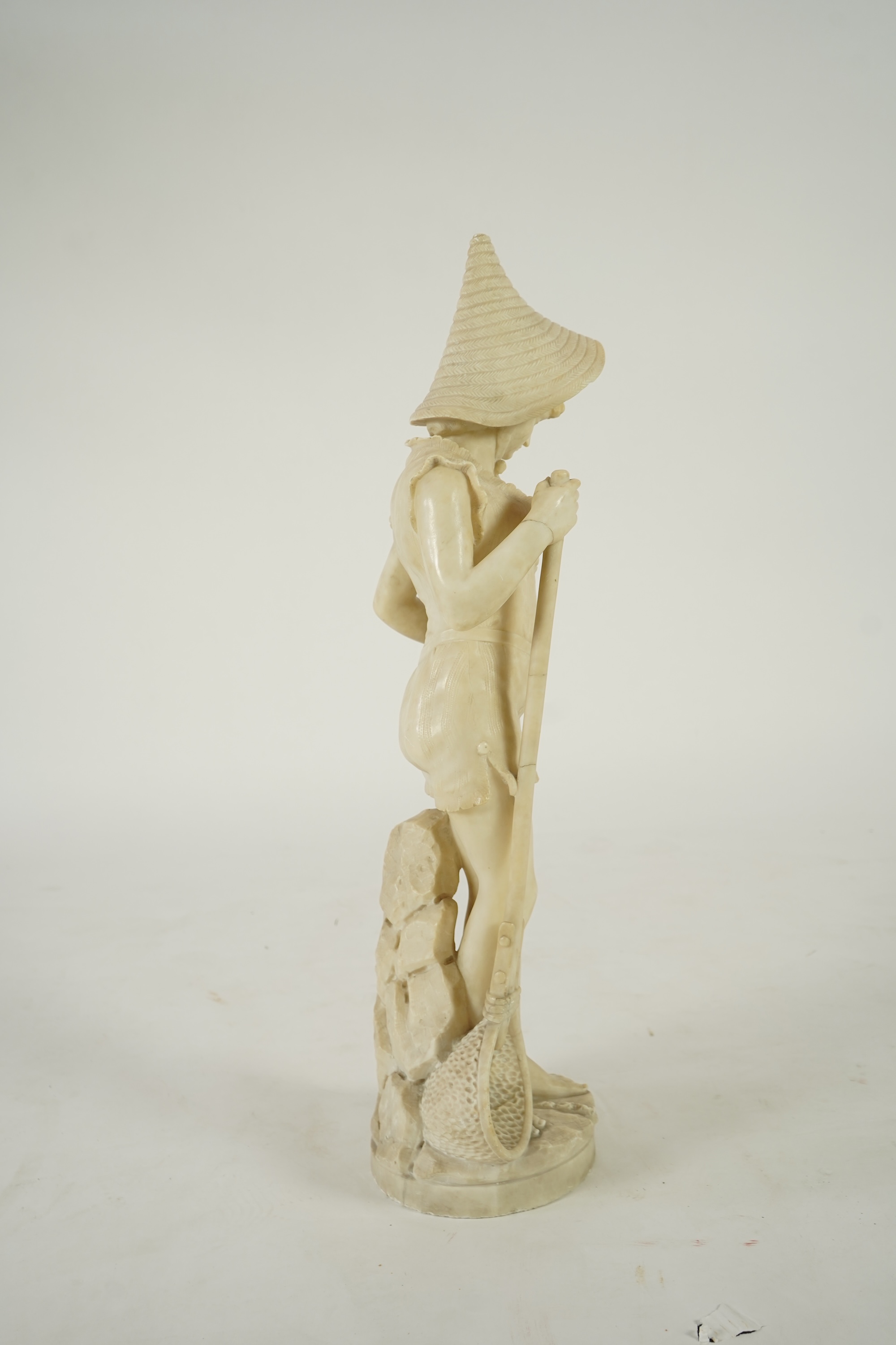 A Continental alabaster figure of a woman fishing, early 20th century